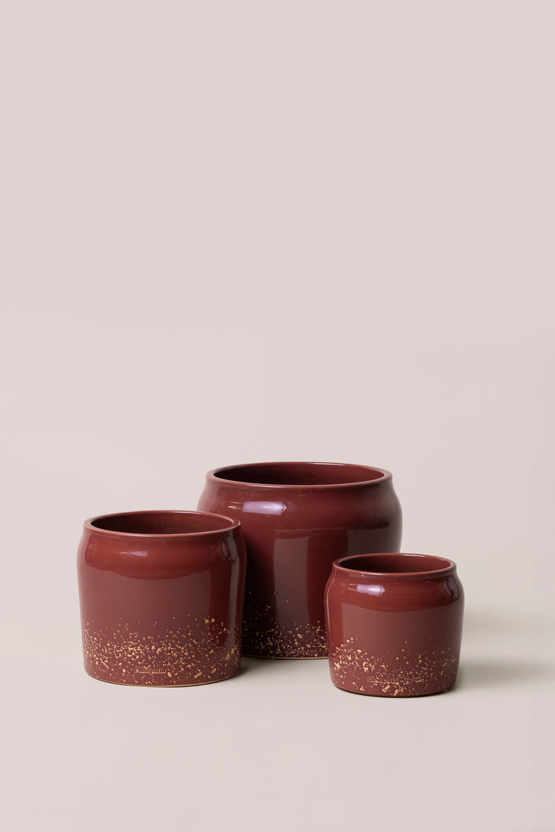 set of three different red planters with different sizes