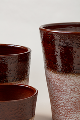 Set of 3 aged terracotta plant pots in brown color.