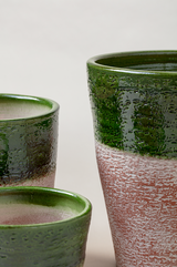 Set of 3 aged terracotta glazed plant pots in green color.