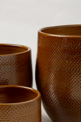 Set of 3 terracotta glazed plant pot in caramel color of different sizes..