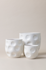 Set of 3 terracotta plant pots in white color.