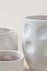 Set of 3 terracotta plant pots in white color.