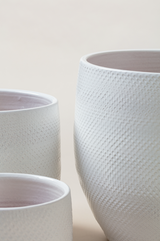 Set of 3 terracotta plant pots in white color.