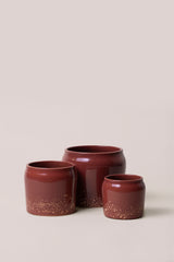set of three different red planters with different sizes