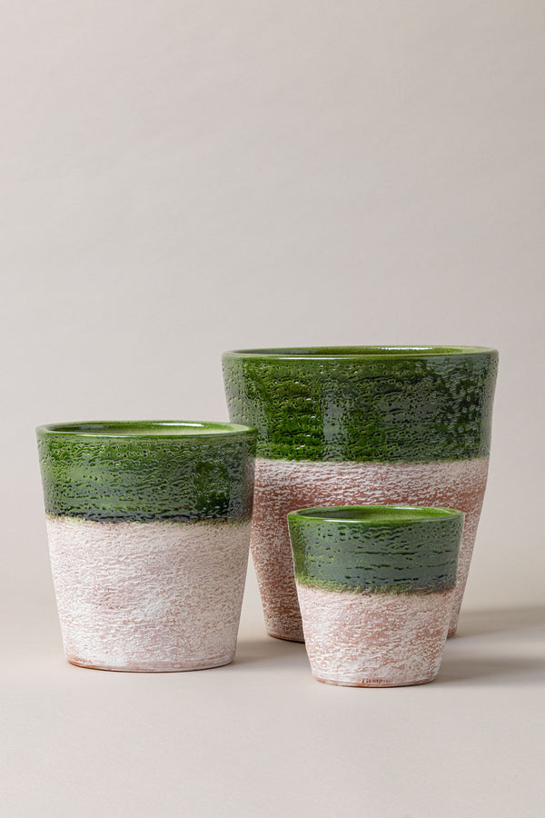 Set of 3 aged terracotta glazed plant pots in green color.