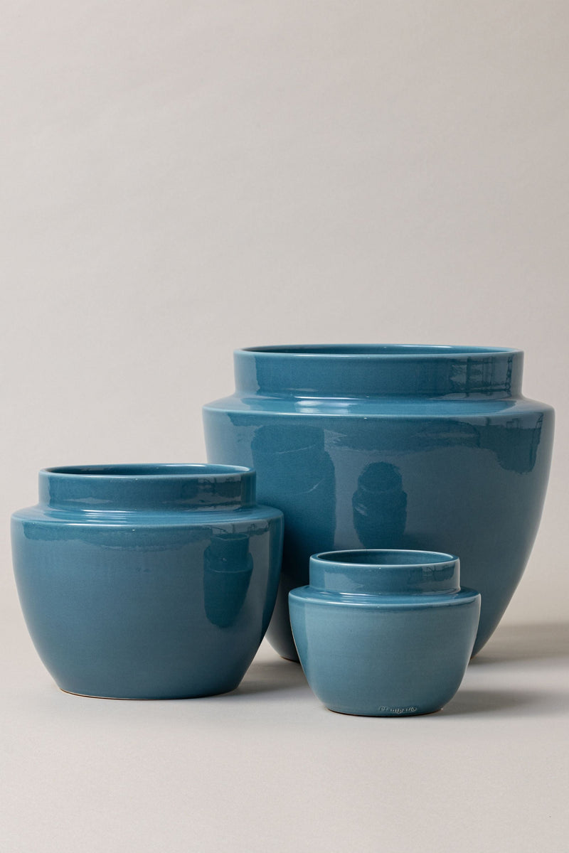set of three Terracotta glazed plant pots of different sizes in blue color