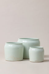 set of three Terracotta glazed plant pots of different sizes in mint green color