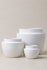 set of three Terracotta glazed plant pots of different sizes in white craclé color