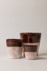 Set of 3 aged terracotta plant pots in brown color.