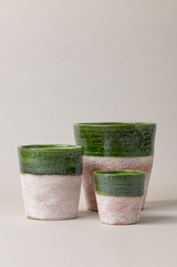 Set of 3 aged terracotta plant pots in green color.