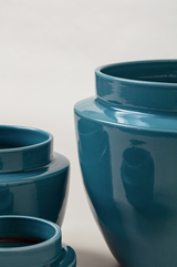 close up of set of three Terracotta glazed plant pots of different sizes in blue color