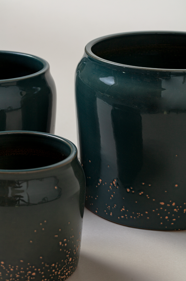 close-up of set of three Terracotta glazed plant pots in juniper green color